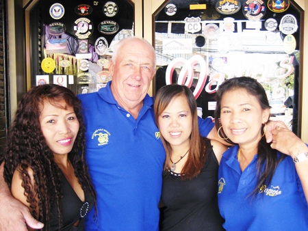 JJ, 2nd left, celebrates his golfing success with the staff at Mama’s Bar.